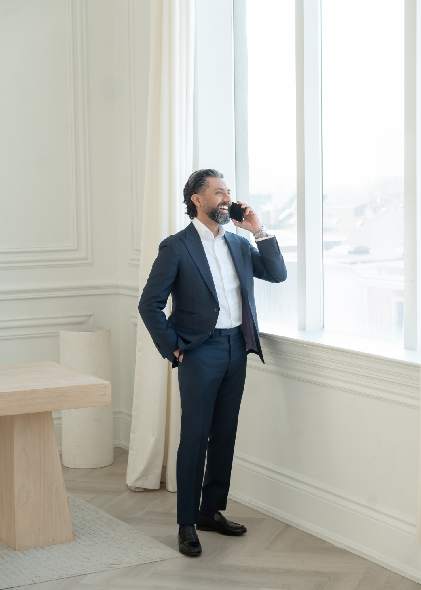 Ajit Saul smiling while on a business call